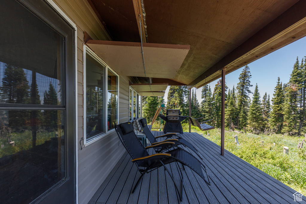 Wooden terrace featuring area for grilling