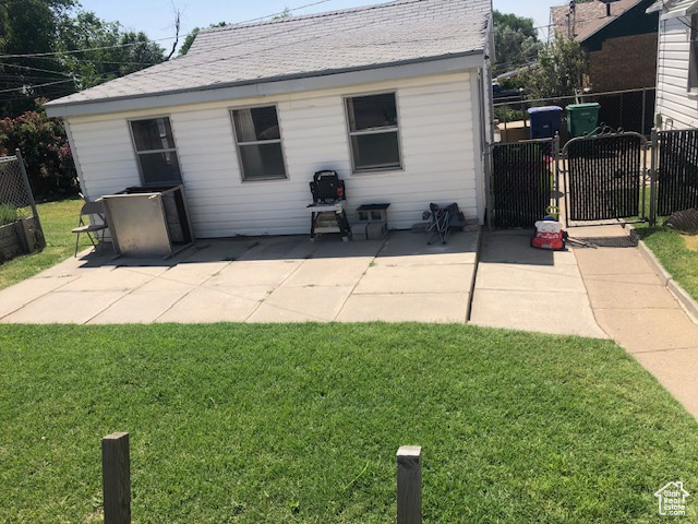 Rear view of property featuring a gate and a patio area