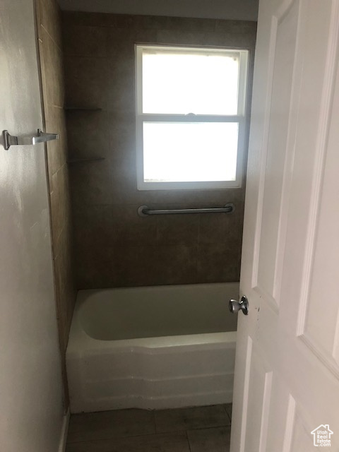 Bathroom featuring tile patterned flooring and shower / bath combination