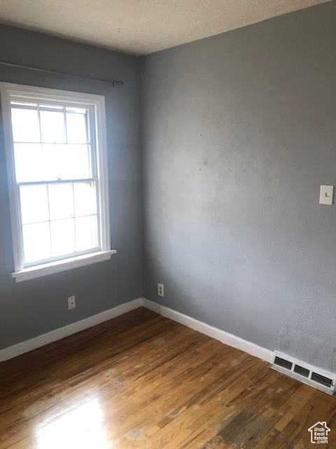 Empty room with wood finished floors and baseboards