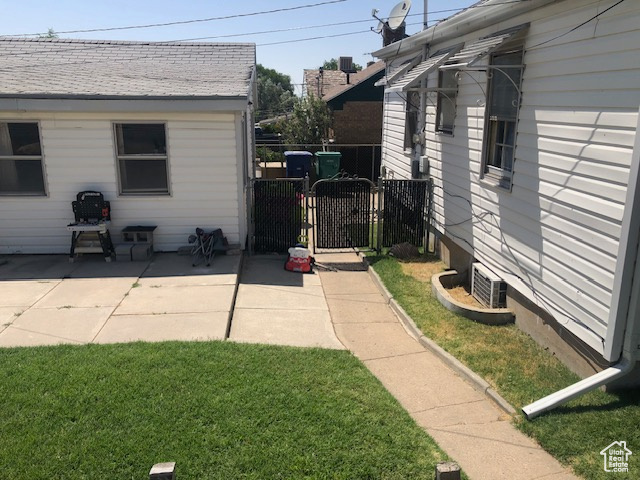 View of yard featuring a gate and a patio area