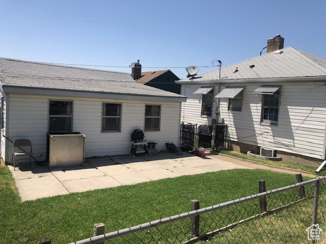 Rear view of property with a patio and a chimney