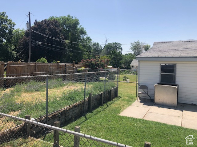 Fenced backyard featuring a patio area