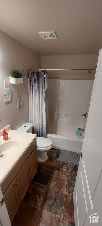 Bathroom featuring vanity and shower / tub combo