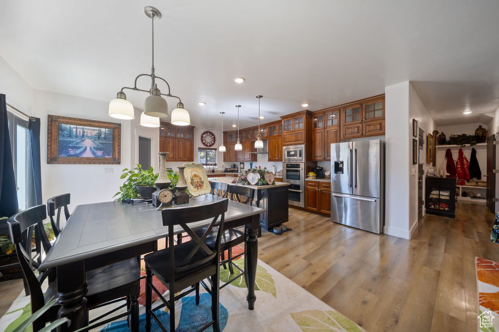 Dining room featuring light wood-style floors, recessed lighting, and healthy amount of natural light