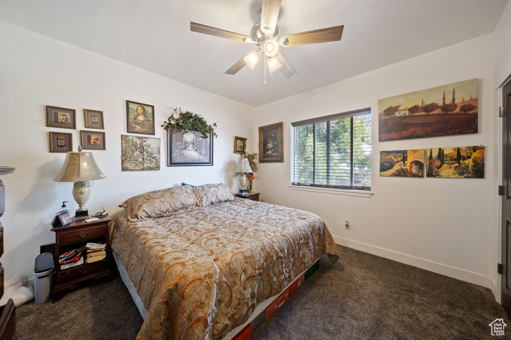 Carpeted bedroom with baseboards and a ceiling fan