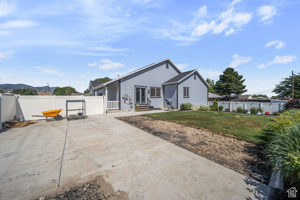 Back of property with a fenced backyard, a patio area, a gate, and a mountain view