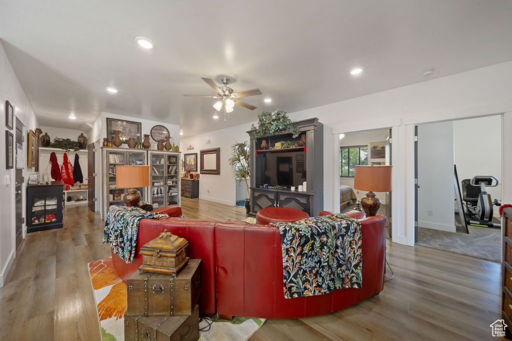 Living room featuring ceiling fan, wood finished floors, and recessed lighting