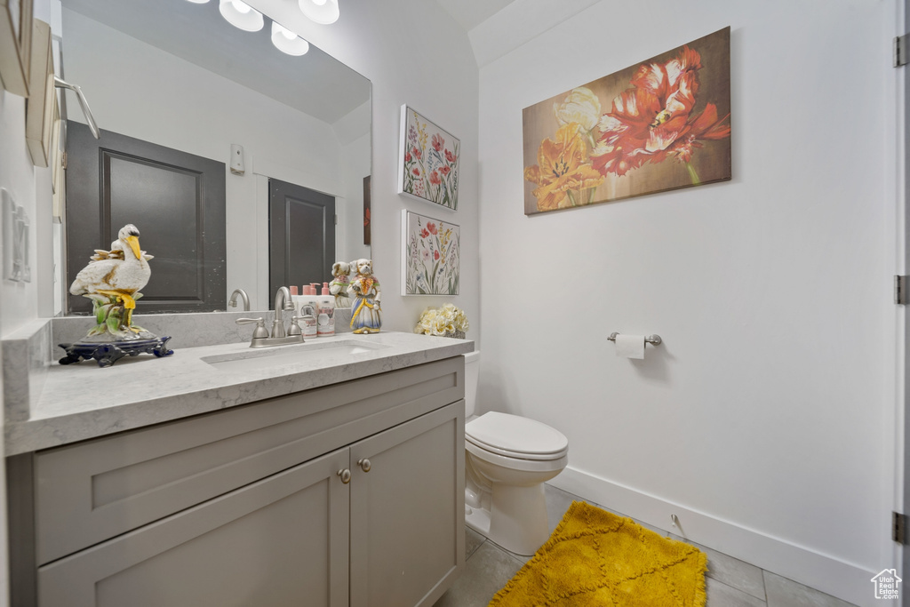 Bathroom with tile patterned floors and vanity