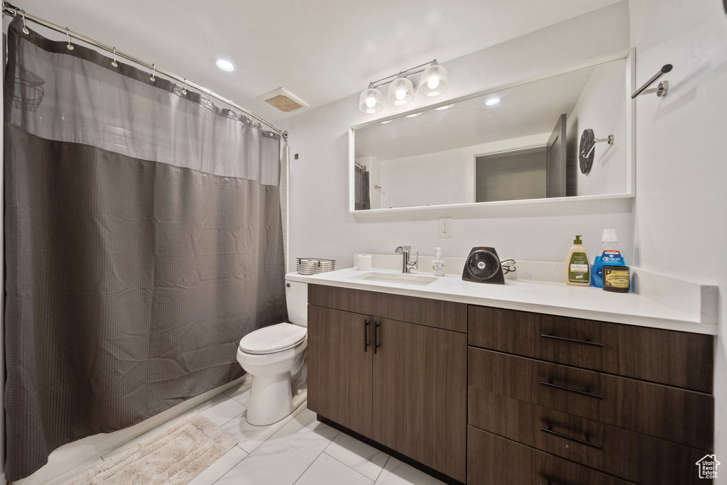 Full bathroom with vanity, marble finish flooring, a shower with curtain, and recessed lighting