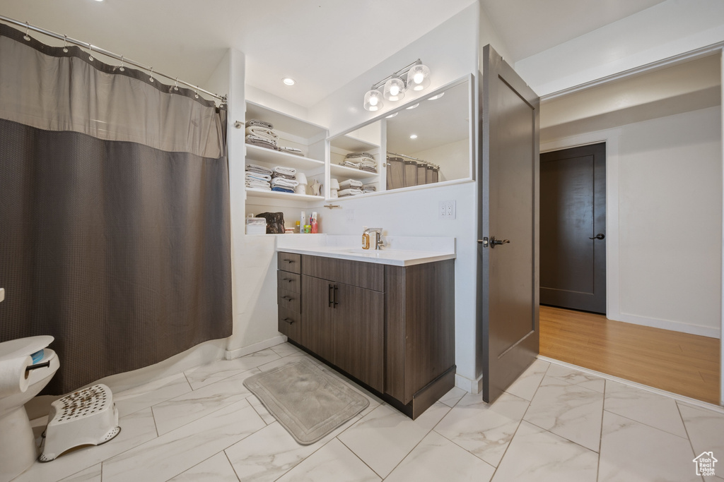 Bathroom with marble look tile flooring, vanity, recessed lighting, and a shower with curtain