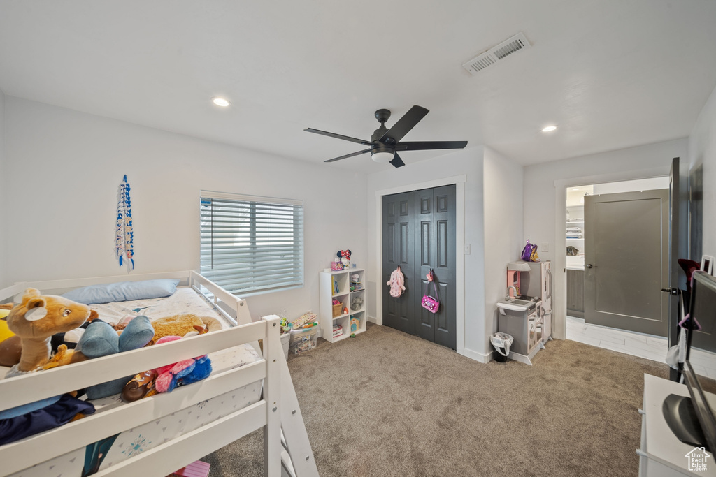 Carpeted bedroom with recessed lighting, ceiling fan, and a closet