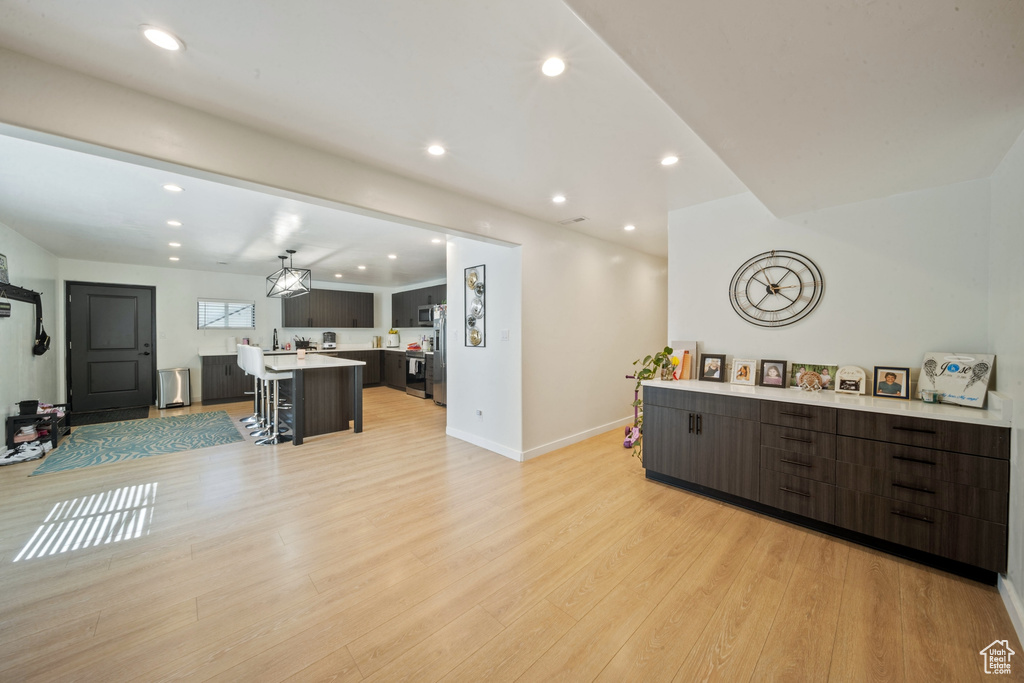 Living room featuring light wood finished floors and recessed lighting