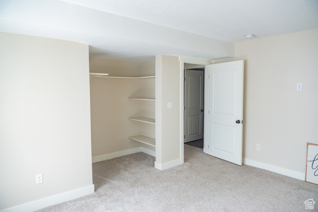 Unfurnished bedroom with carpet floors and a closet