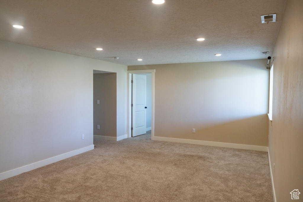 Unfurnished room featuring carpet flooring and recessed lighting