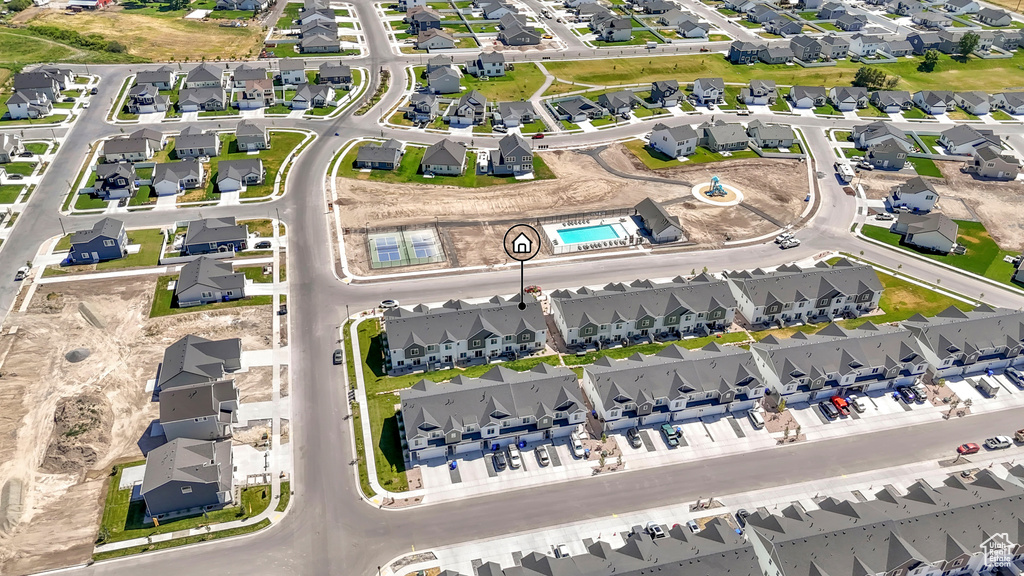 Aerial view of property and surrounding area featuring nearby suburban area