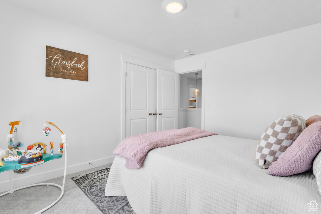 Carpeted bedroom featuring baseboards