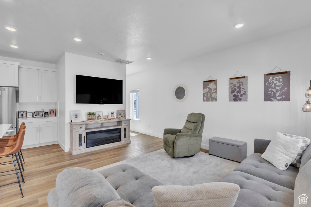 Living room featuring light wood-style floors and recessed lighting