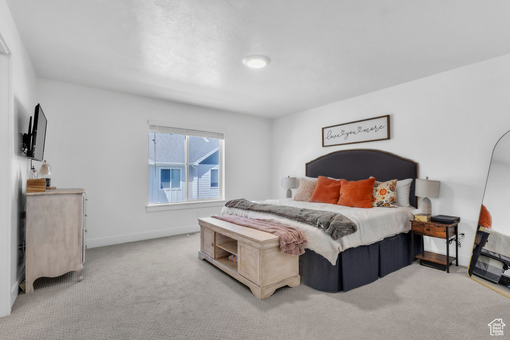 Carpeted bedroom featuring baseboards