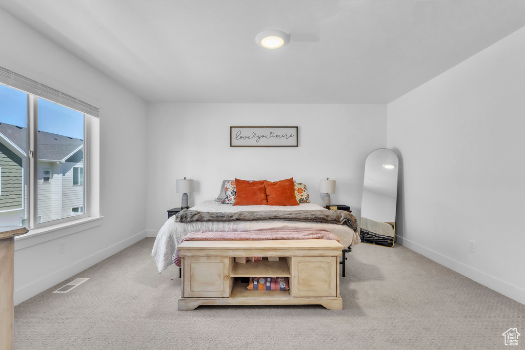 Bedroom with light colored carpet