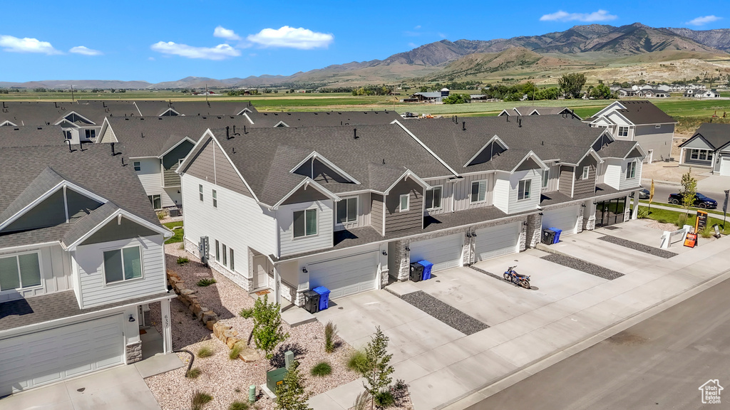 Aerial view of residential area featuring a mountainous background