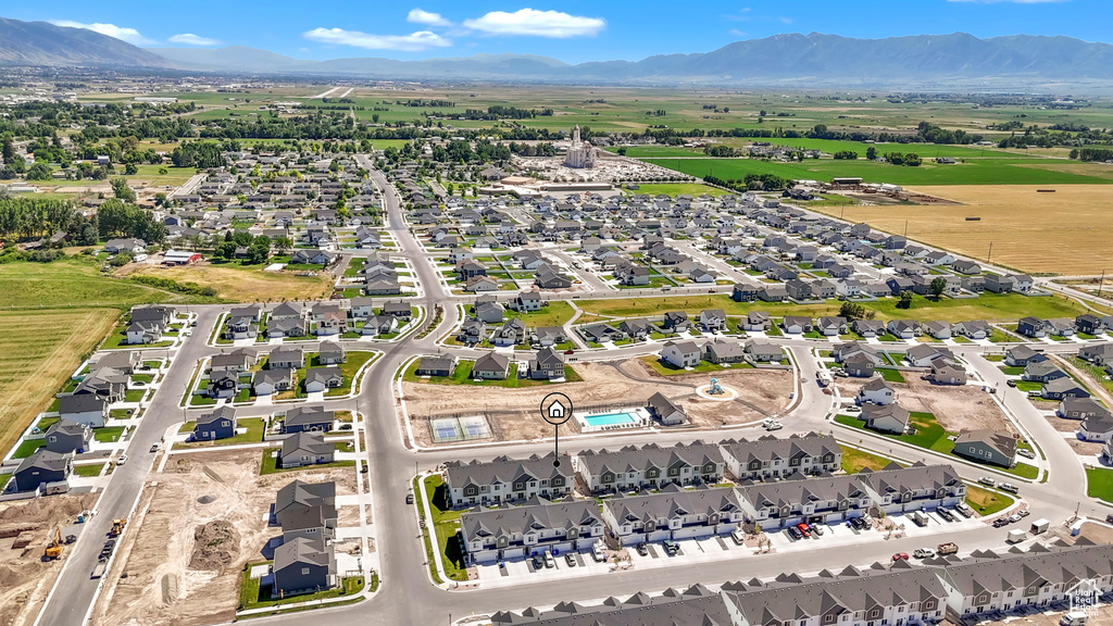 Aerial view of property and surrounding area with a mountainous background