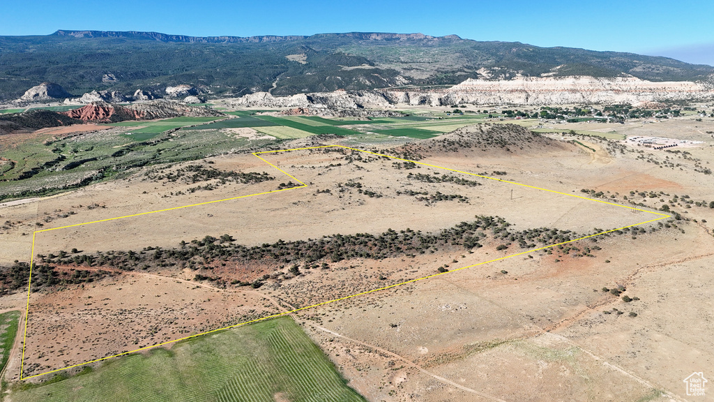 View of rural area with a mountainous background and property boundaries highlighted