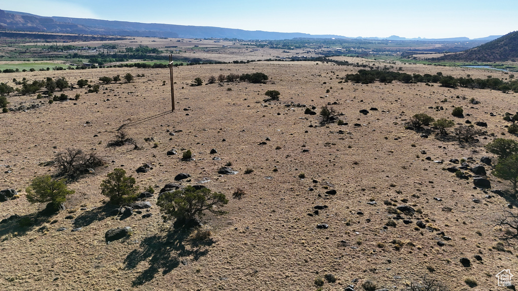 Aerial view of sparsely populated area with a mountain backdrop and a desert landscape