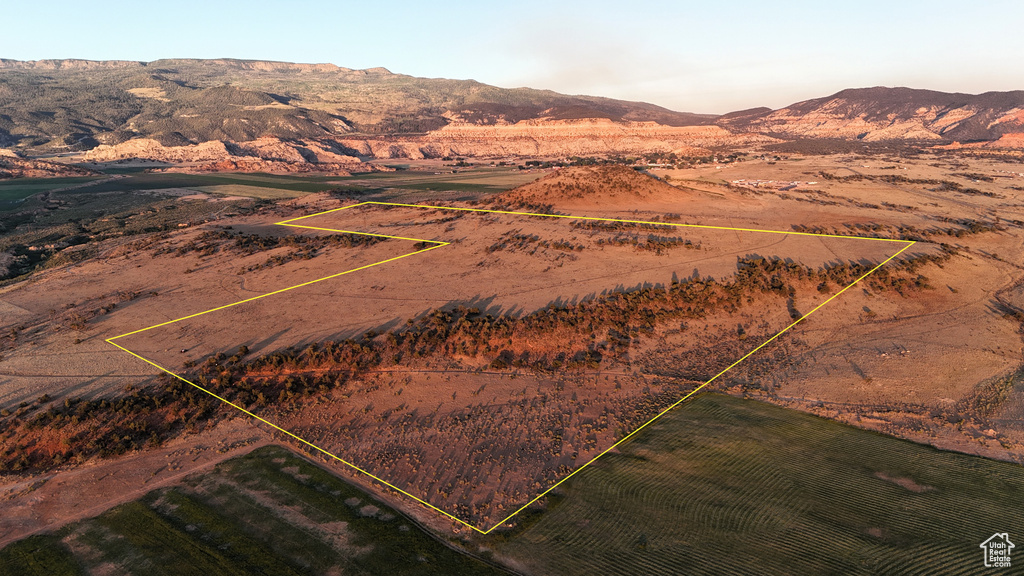 Aerial view of sparsely populated area featuring a mountain backdrop and property boundaries highlighted
