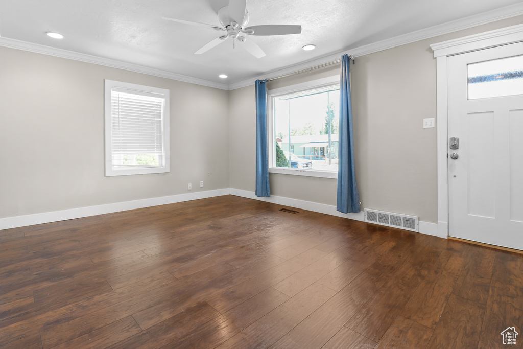 Entryway with ornamental molding, a ceiling fan, recessed lighting, and hardwood / wood-style flooring