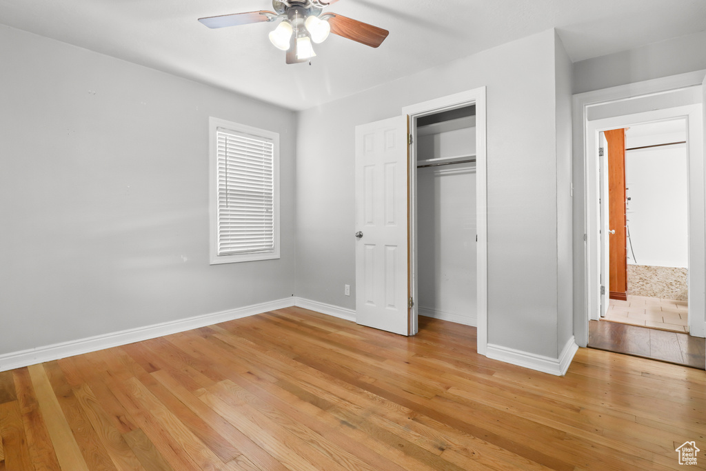Unfurnished bedroom with light wood finished floors, a closet, and ceiling fan