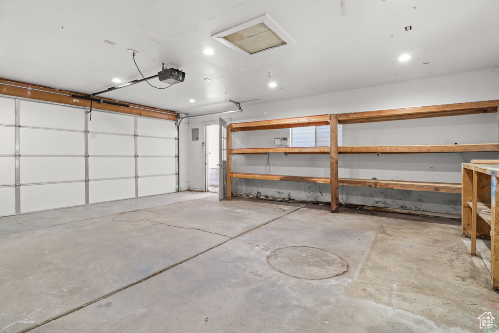 Garage featuring a garage door opener and recessed lighting