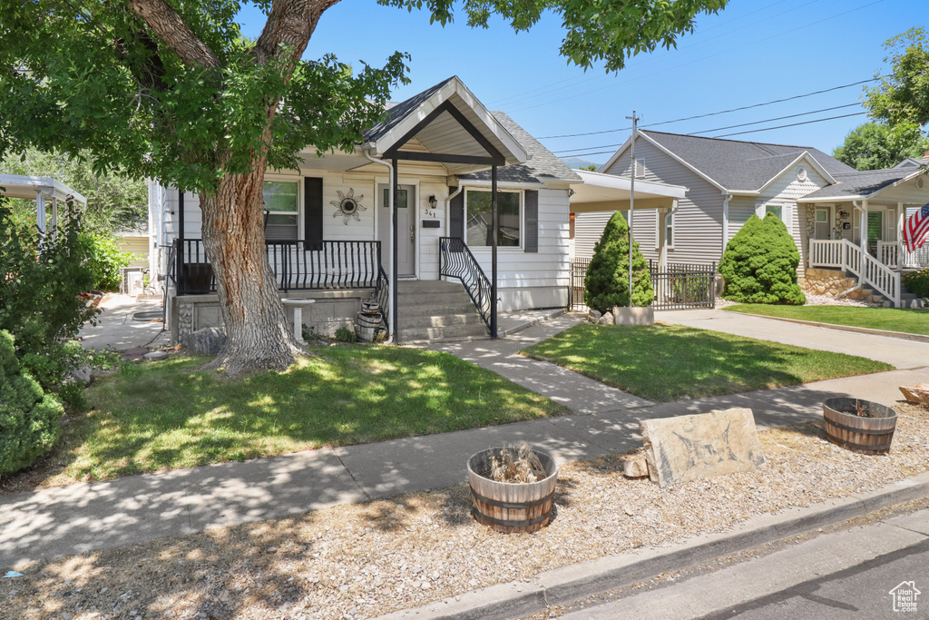 View of front of house with a porch and a front lawn