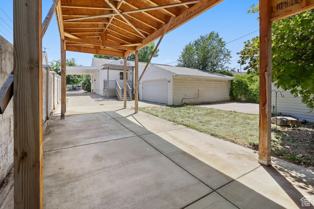 View of patio featuring an outdoor structure and a garage