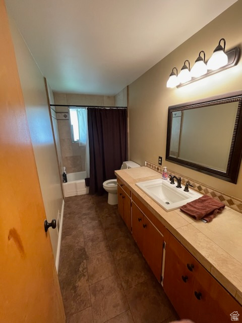 Full bath with vanity, shower / tub combo with curtain, and tile patterned flooring