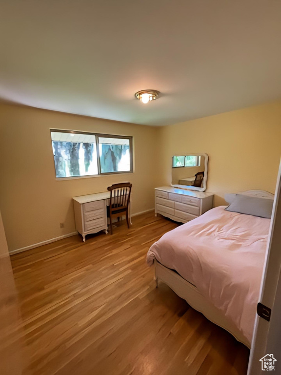 Bedroom with light wood-style floors