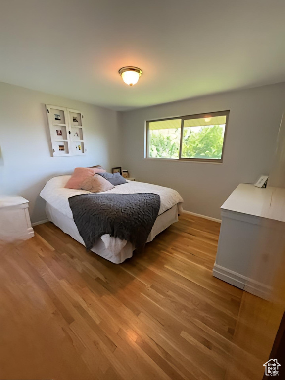 Bedroom featuring light wood-type flooring and baseboards