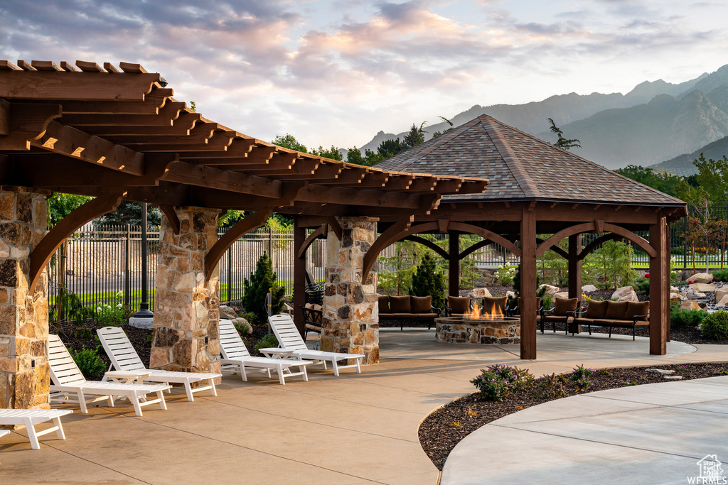 Surrounding community featuring an outdoor living space, a mountain view, a patio, and a gazebo