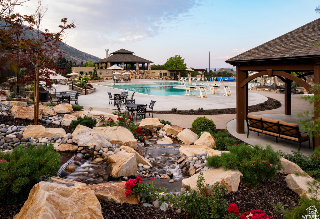 Community pool featuring a gazebo, a patio, and a mountain view
