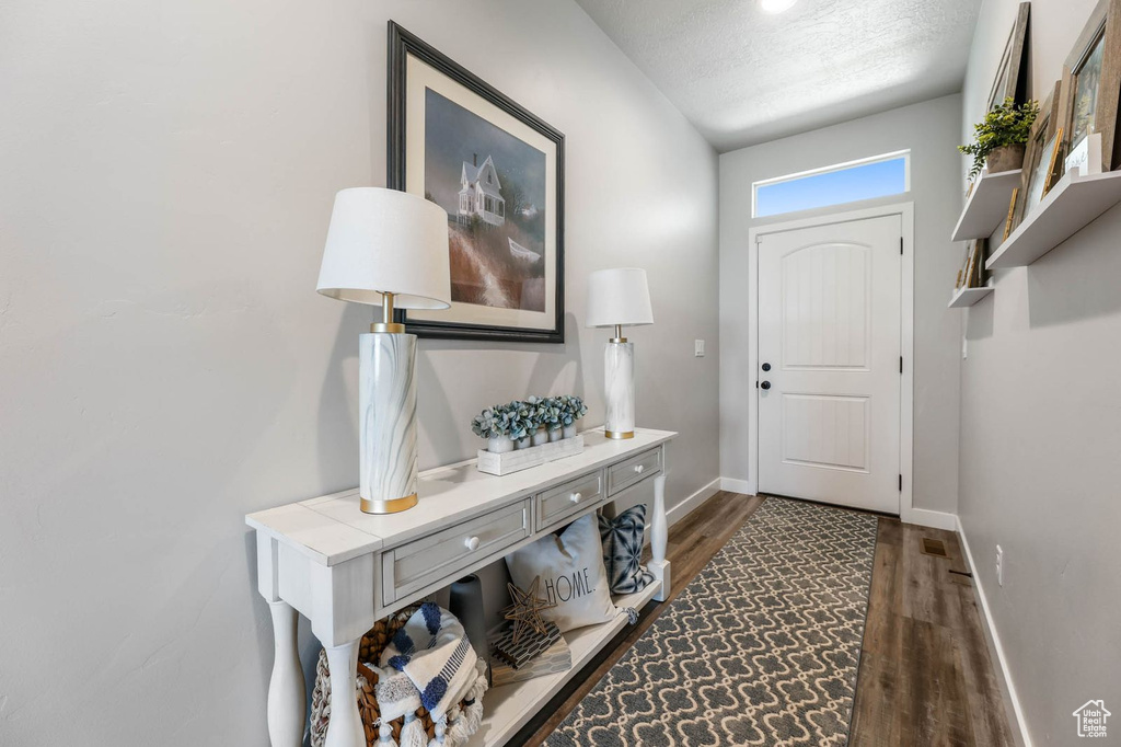 Entryway featuring wood finished floors and a textured ceiling