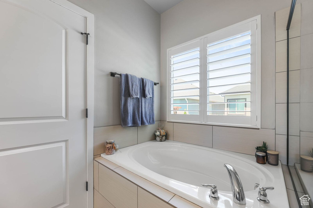 Full bathroom featuring a bath