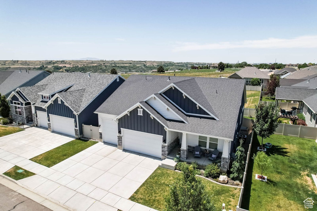 View of front of home featuring board and batten siding, roof with shingles, and a garage