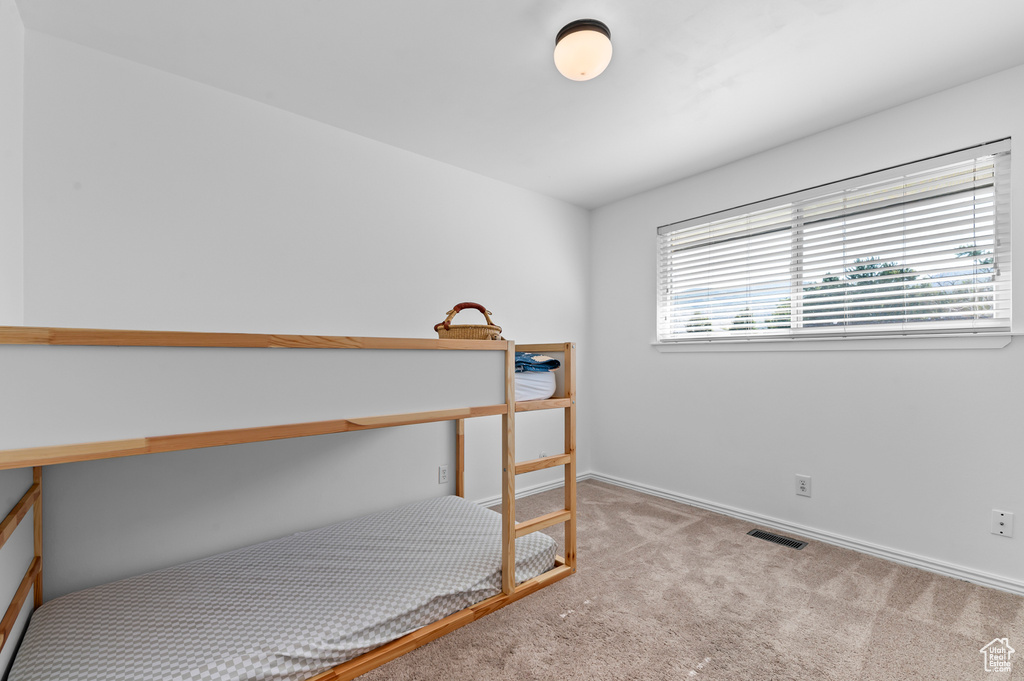 Unfurnished bedroom featuring carpet and baseboards