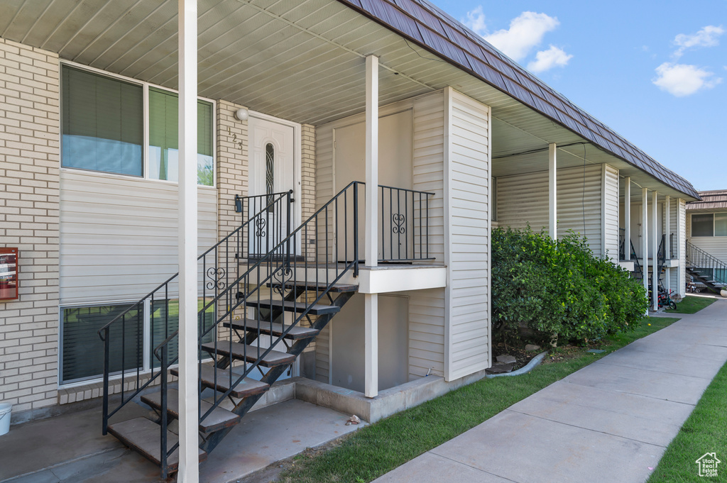 View of exterior entry with brick siding