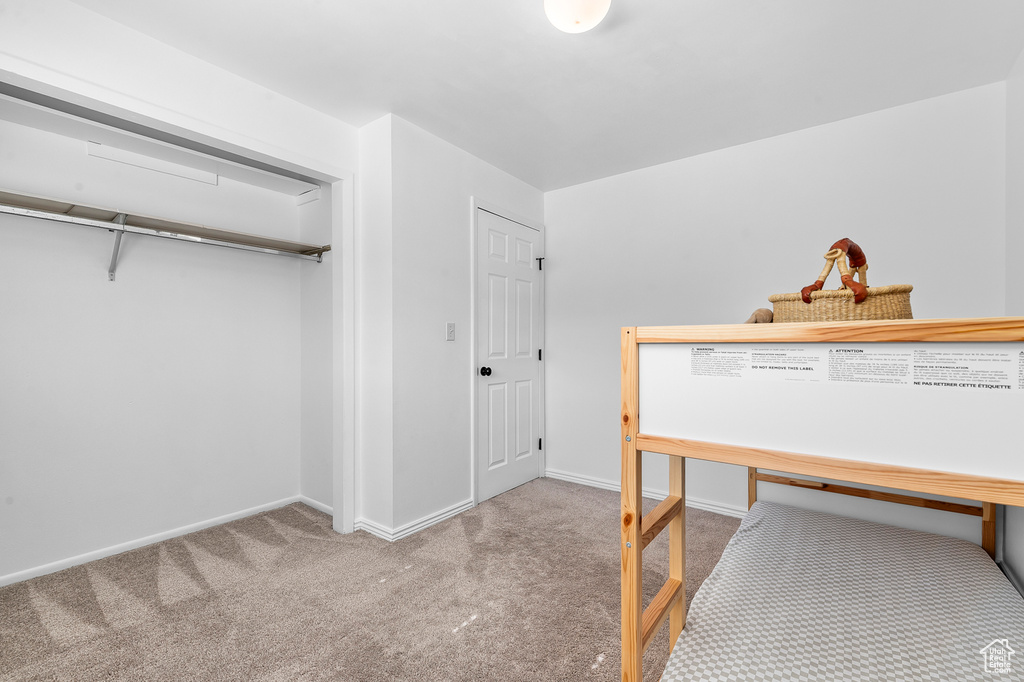 Bedroom with carpet flooring and baseboards