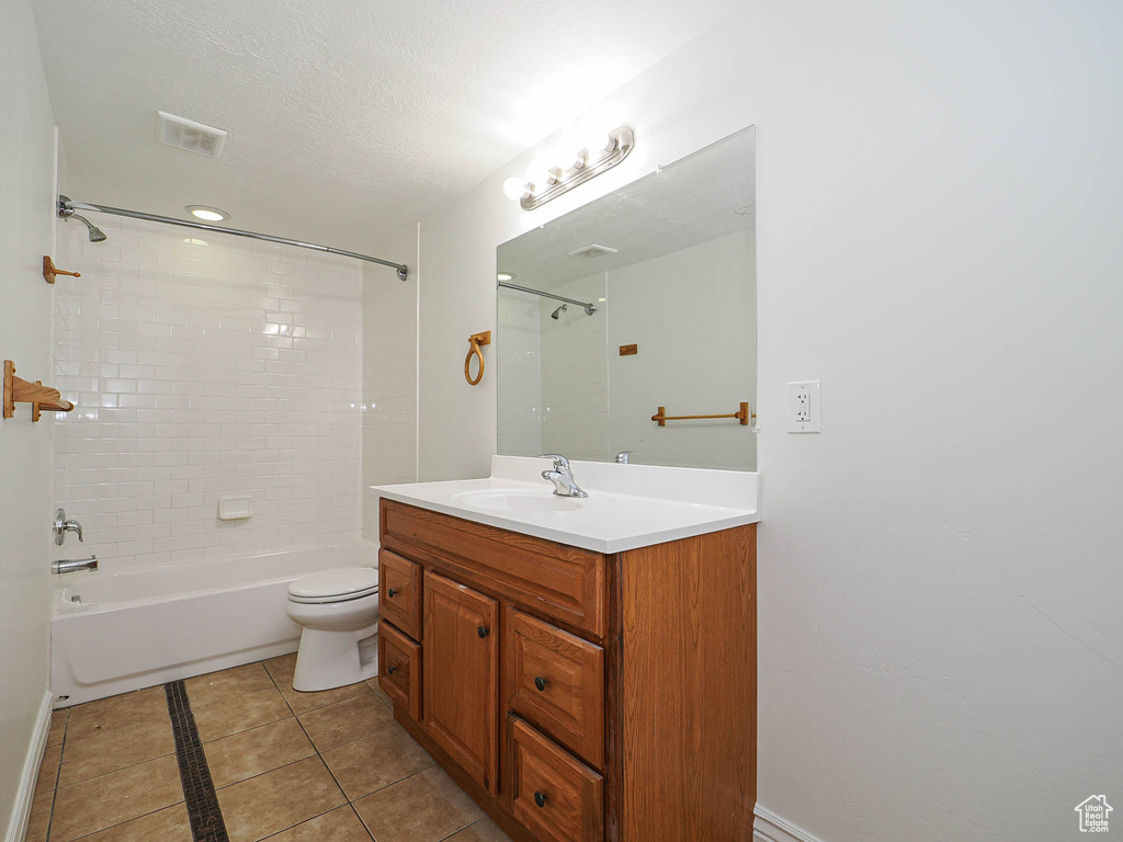 Bathroom with tub / shower combination, vanity, and tile patterned flooring