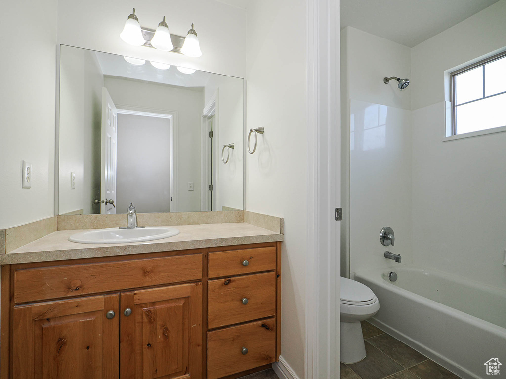 Bathroom with vanity, shower / tub combination, and tile patterned flooring