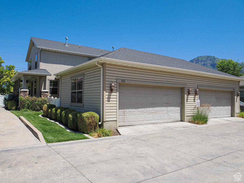 View of home's exterior featuring concrete driveway, a garage, and a mountain view