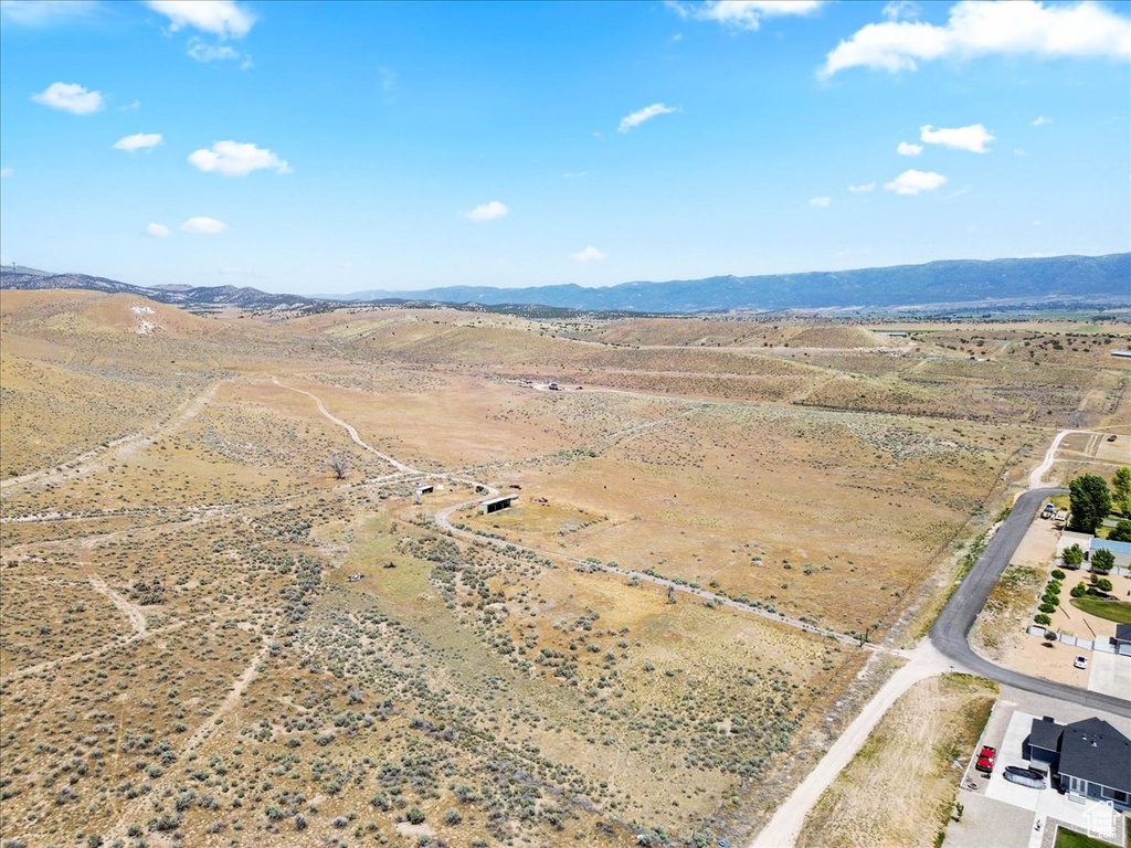 Overview of rural landscape featuring a mountain backdrop and a desert landscape