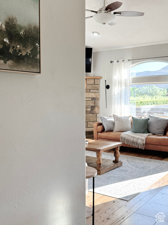 Living room with ceiling fan and wood finished floors